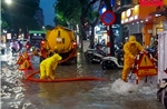 Người dân Hà Nội bì bõm lội nước trong trận mưa lớn
